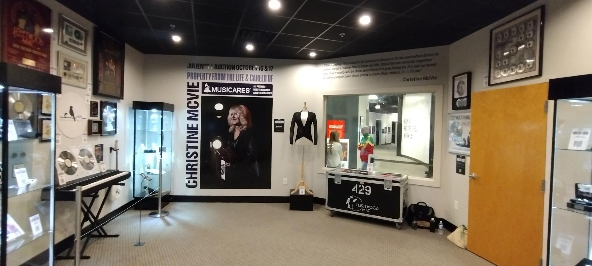 a room with a picture of christine mcvine on the wall .