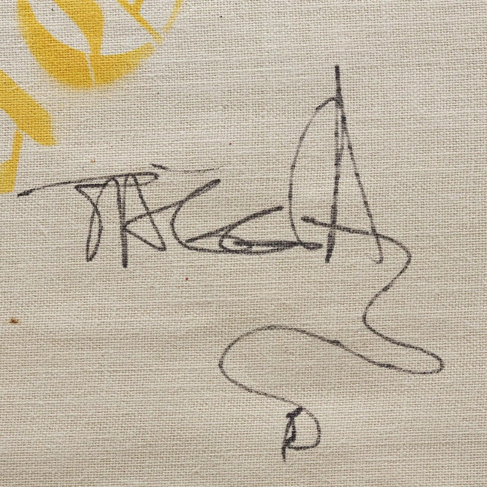 Stylized black ink signature on a cream-colored canvas with a partial yellow design.
