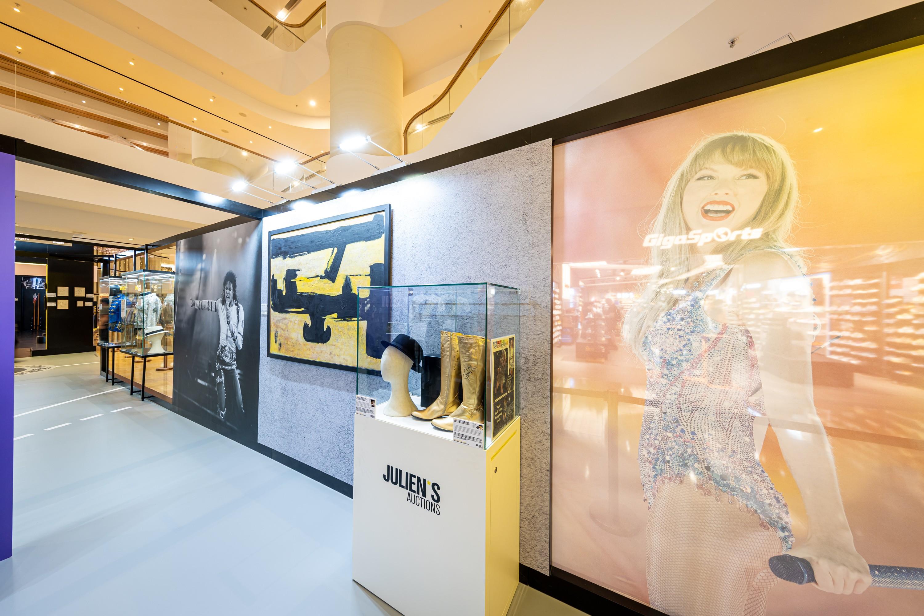 a room with a lot of pictures on the wall and a display case .