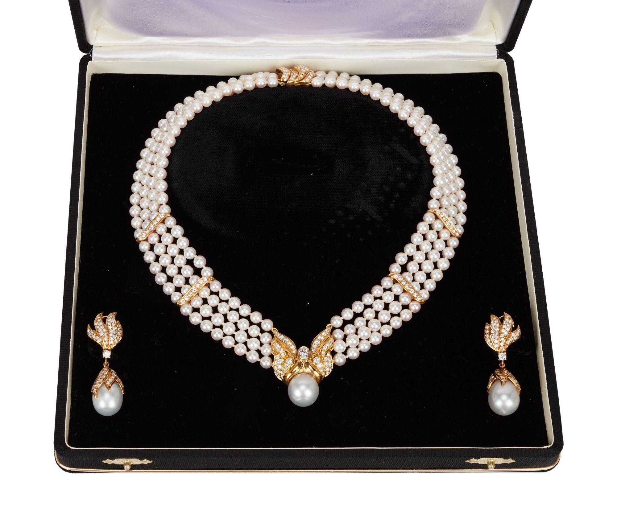 a pearl necklace and earring set in a black box .