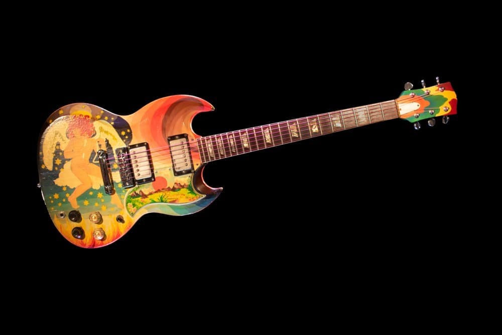 a colorful electric guitar on a black background .