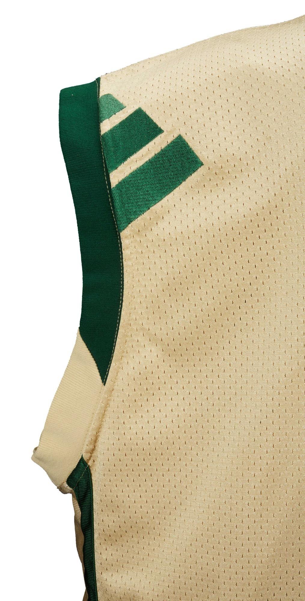 a white jersey with green stripes on the sleeves
