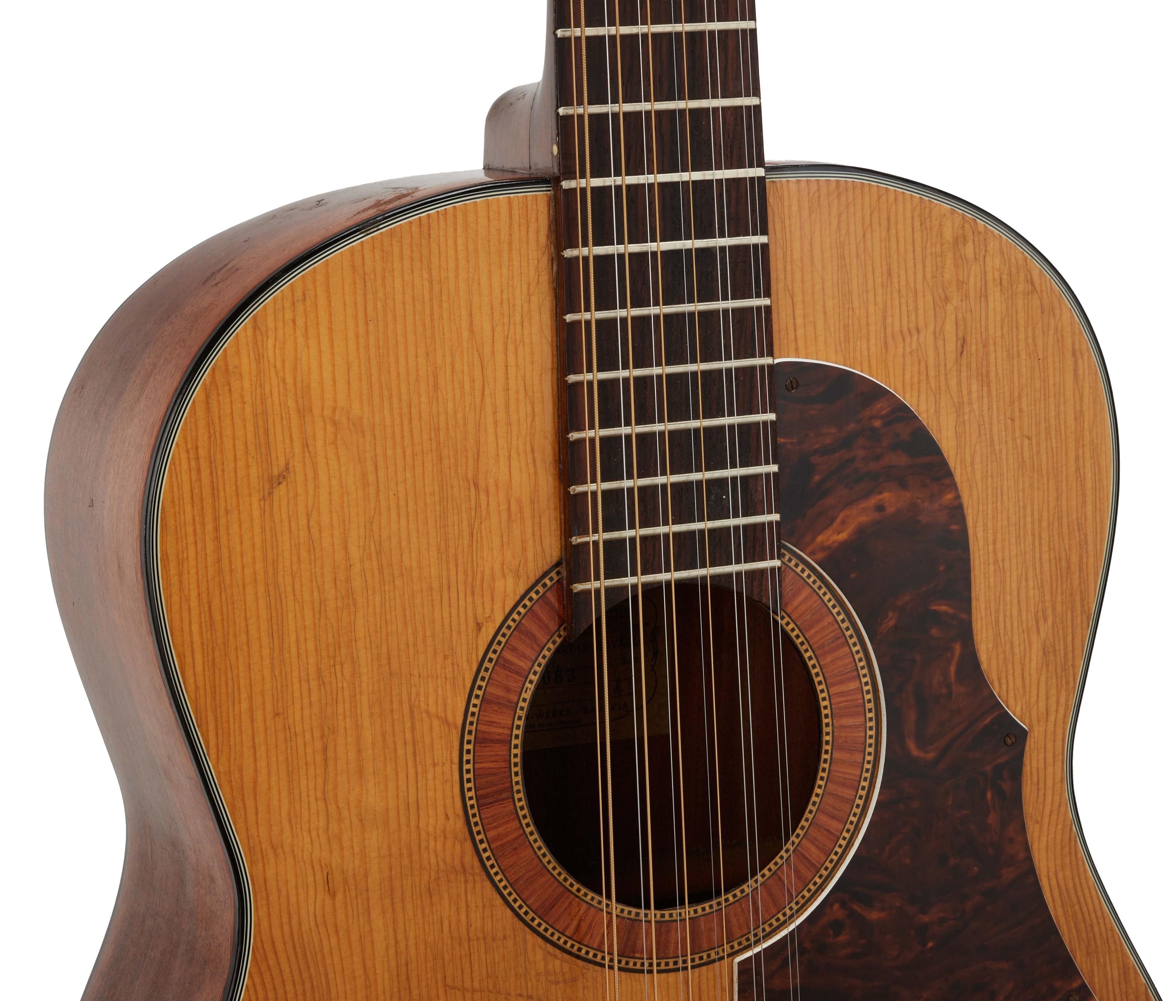 a close up of an acoustic guitar on a white background .