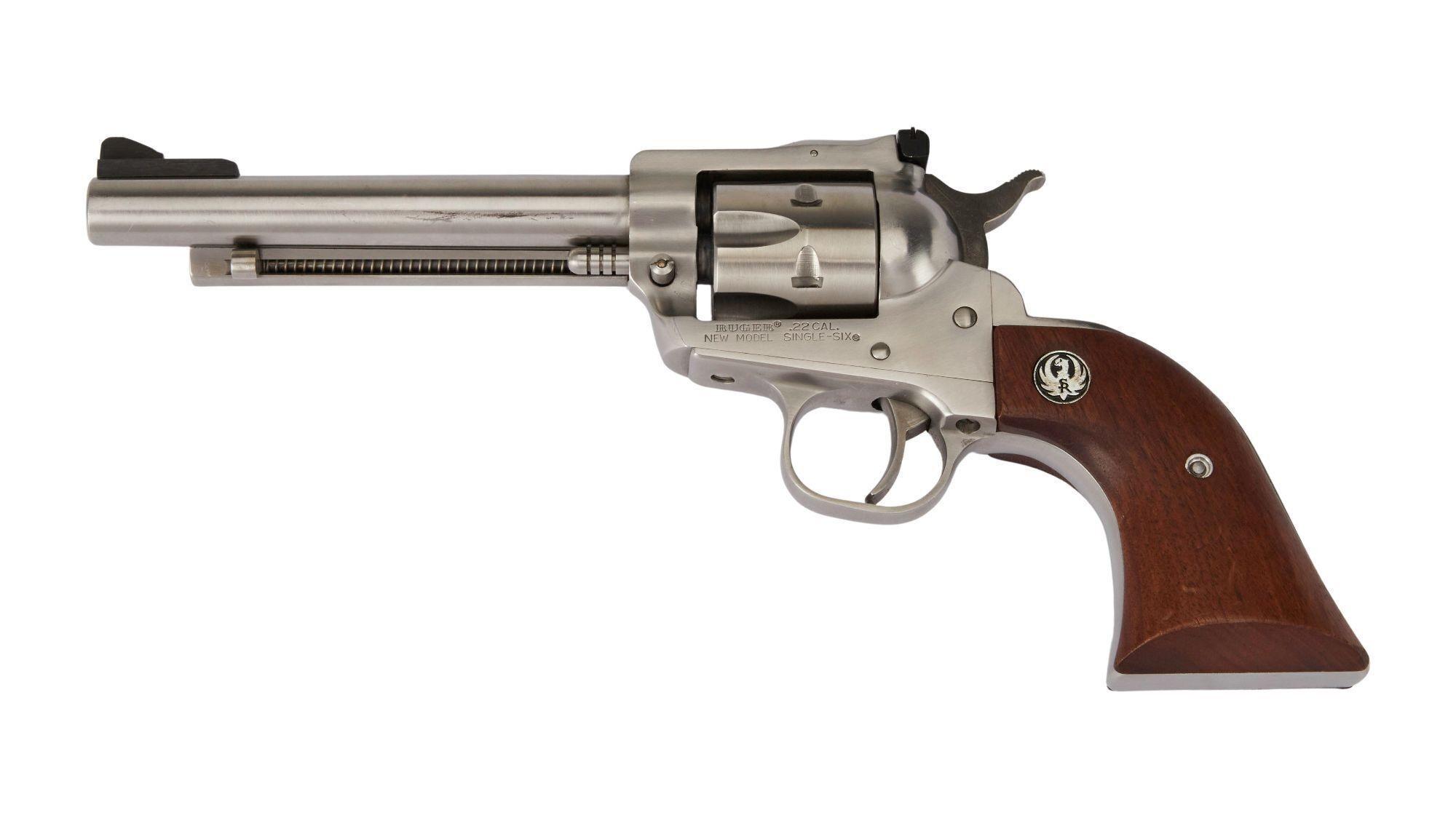 a stainless steel revolver with a wooden grip on a white background .
