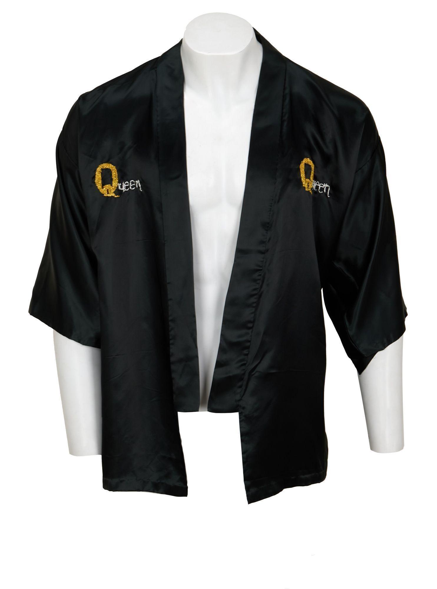 Lot #49. Freddie Mercury | Personally Owned Kimono a black jacket with the word queen embroidered on it